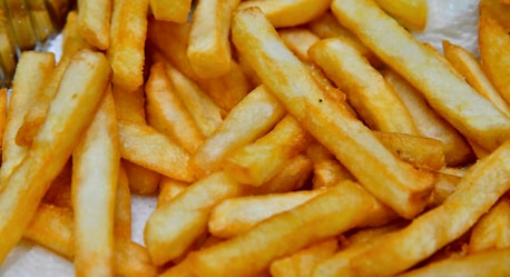 a pile of french fries sitting on top of a table