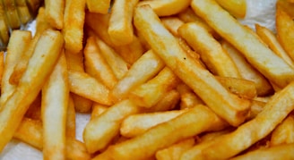 a pile of french fries sitting on top of a table