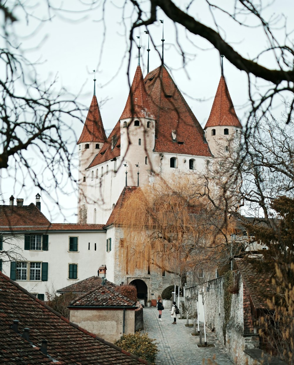 a large white castle with red roof tops