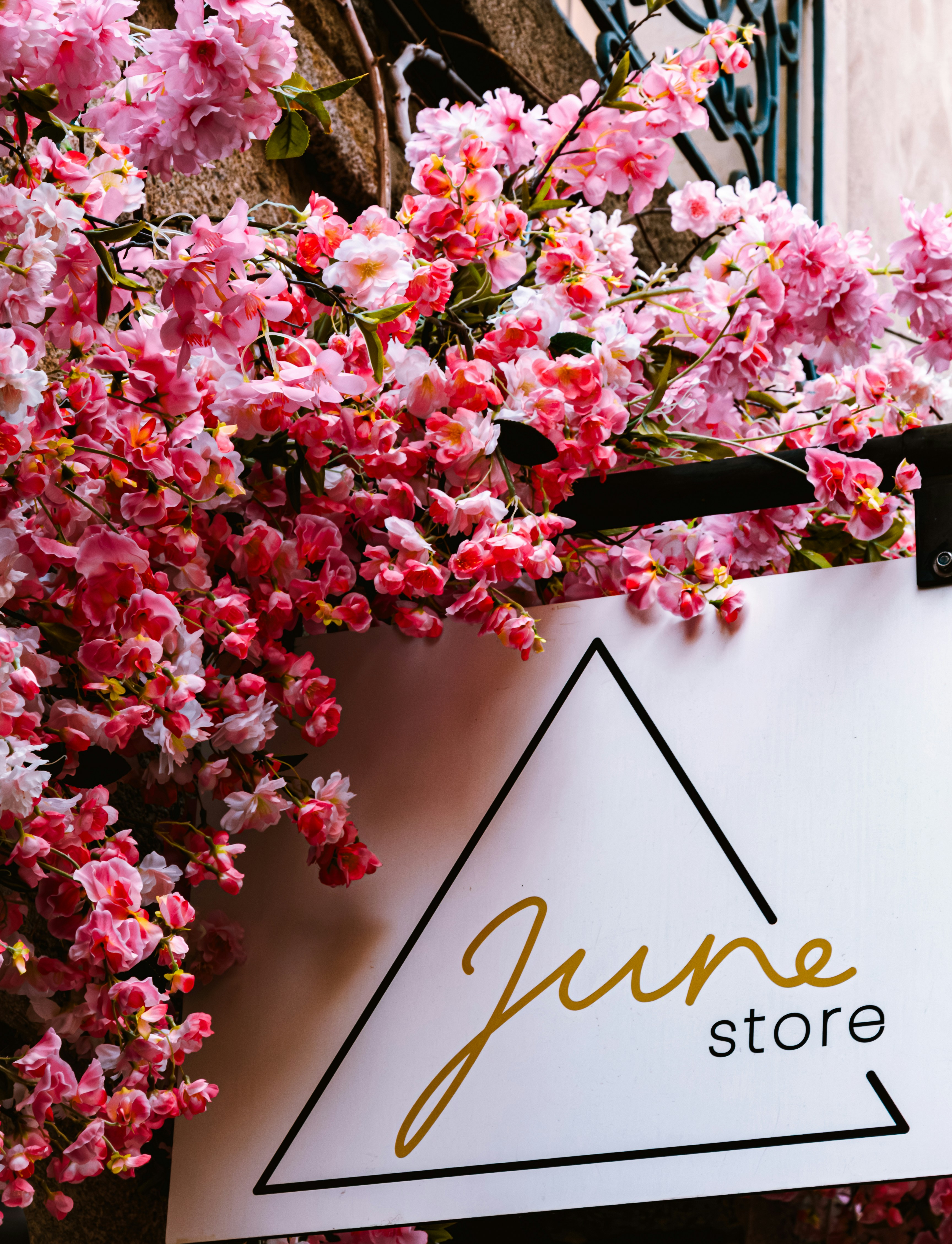 A store sign hanging from the side of a building photo – Free Rennes ...