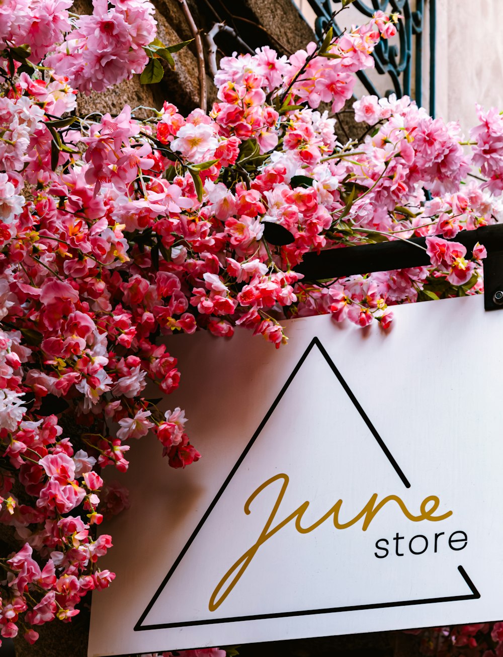 a store sign hanging from the side of a building