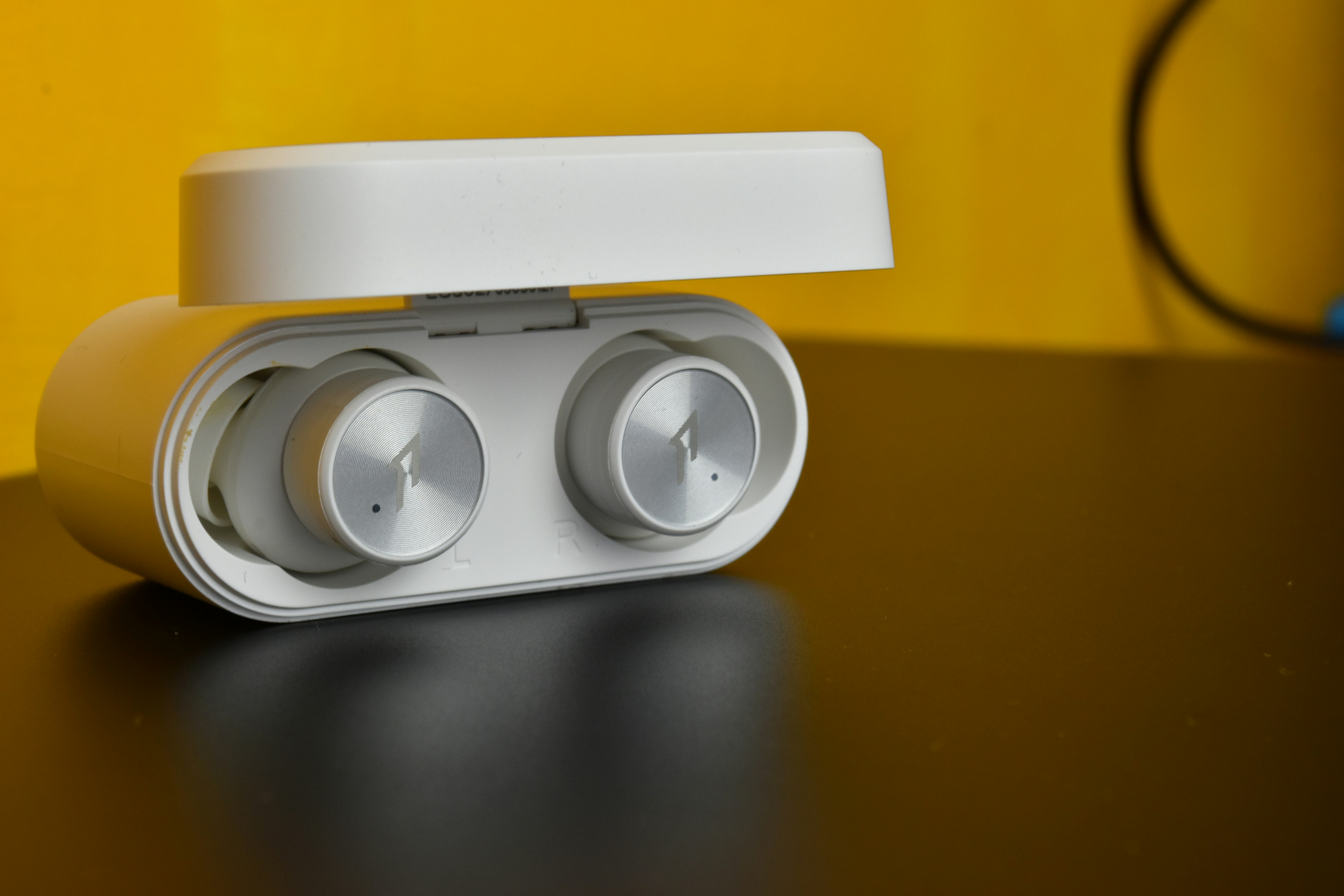 a pair of ear buds sitting on top of a table