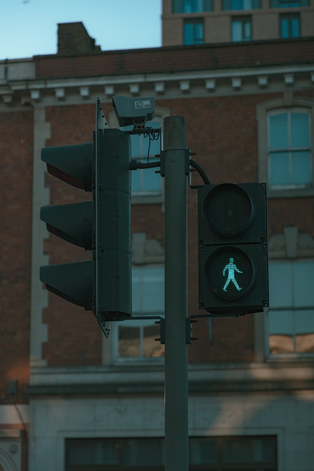 a traffic light with a green pedestrian crossing signal