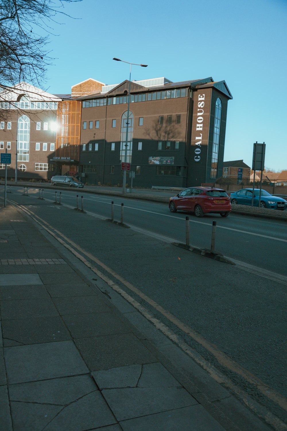 a city street with cars parked on the side of the road