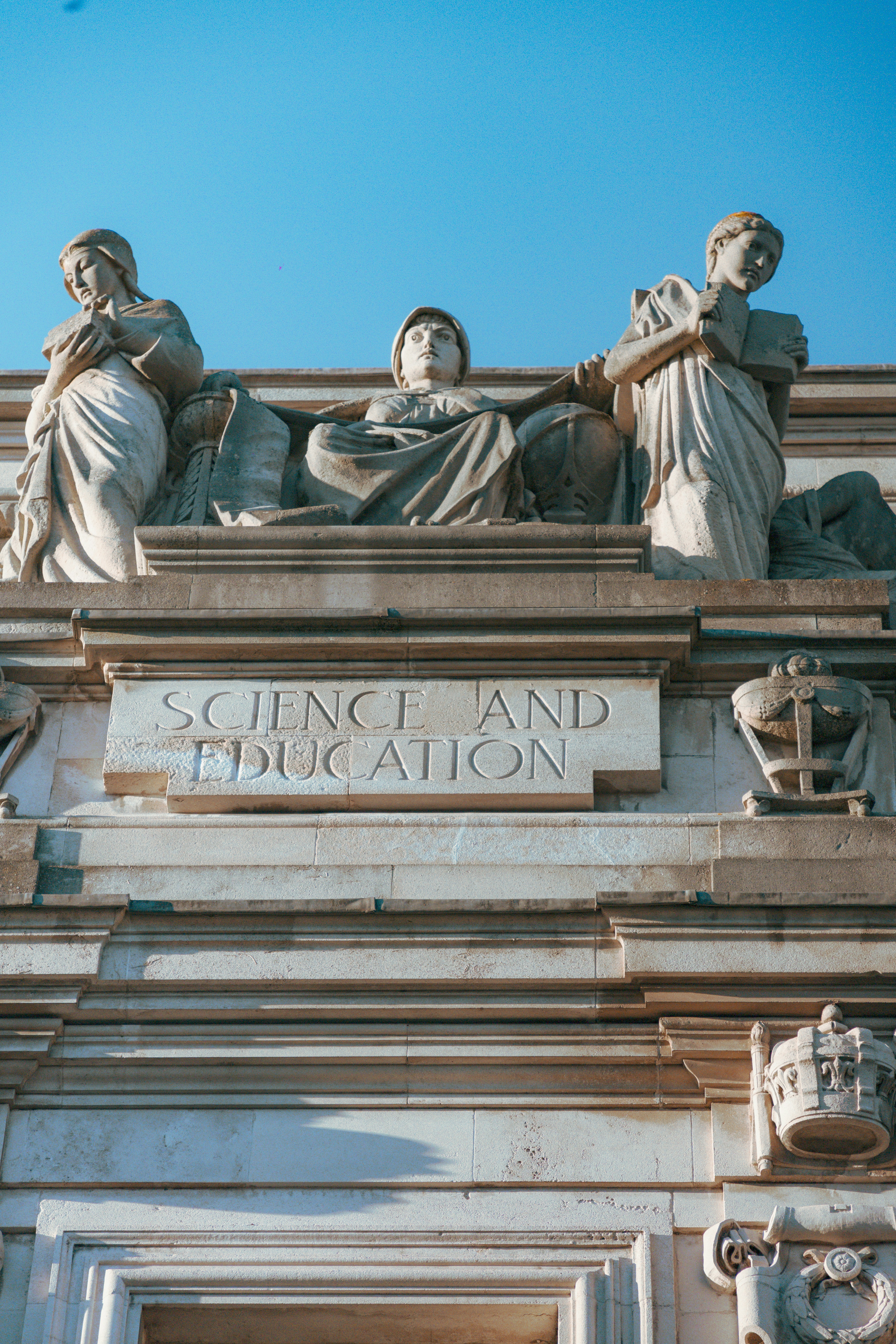 a close up of a building with statues on it