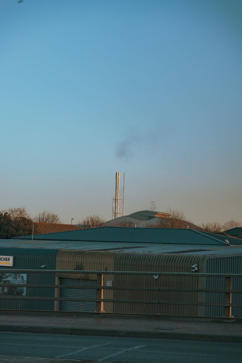 a factory building with smoke coming out of it