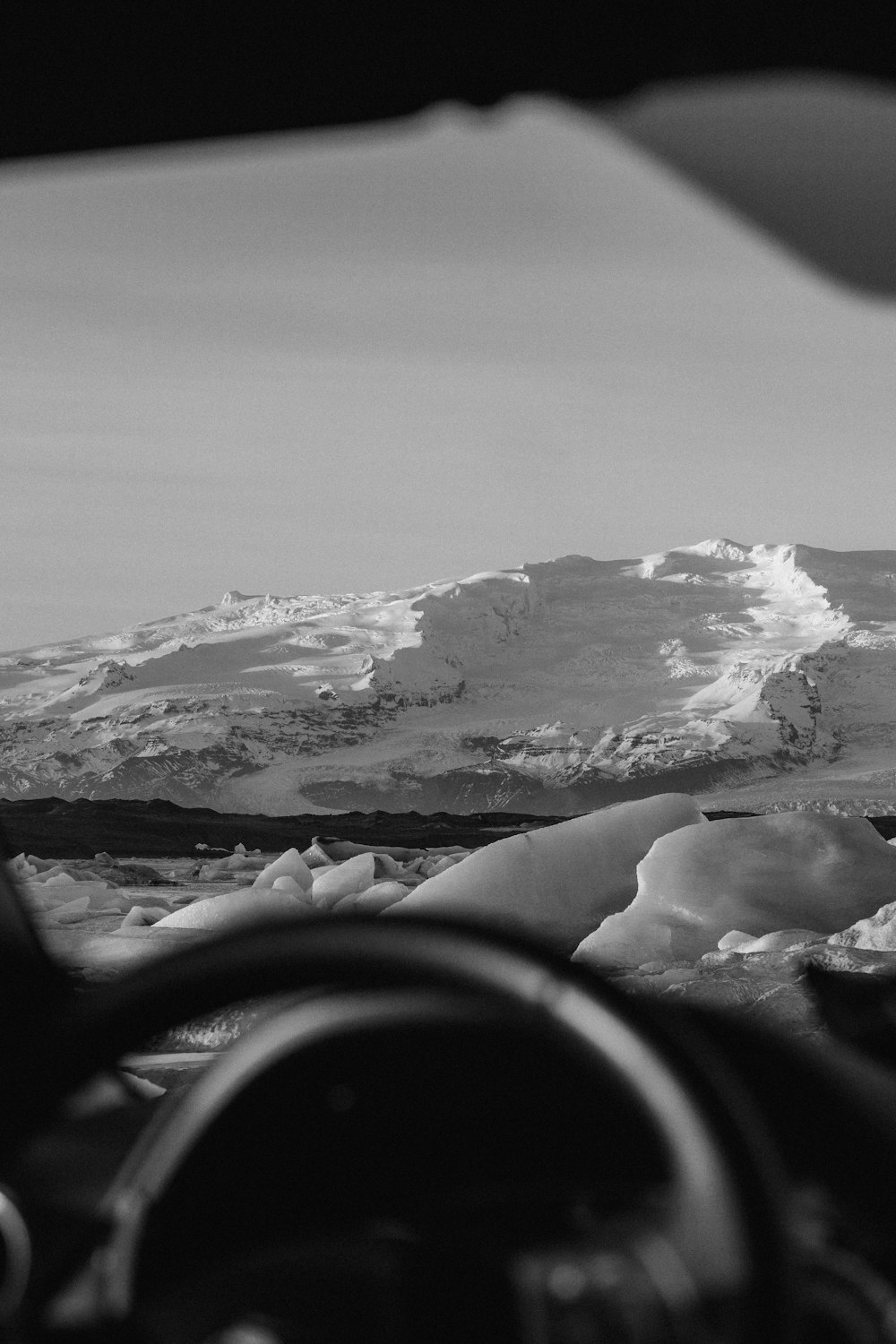 a black and white photo of a snow covered mountain