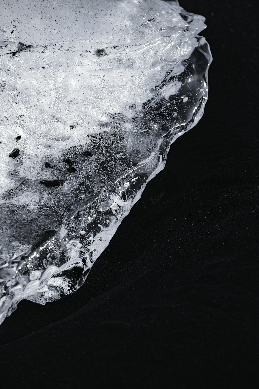 a piece of ice on a black surface