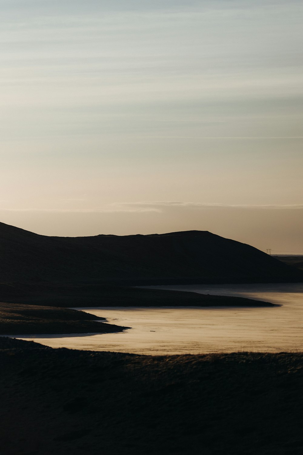 a large body of water surrounded by hills