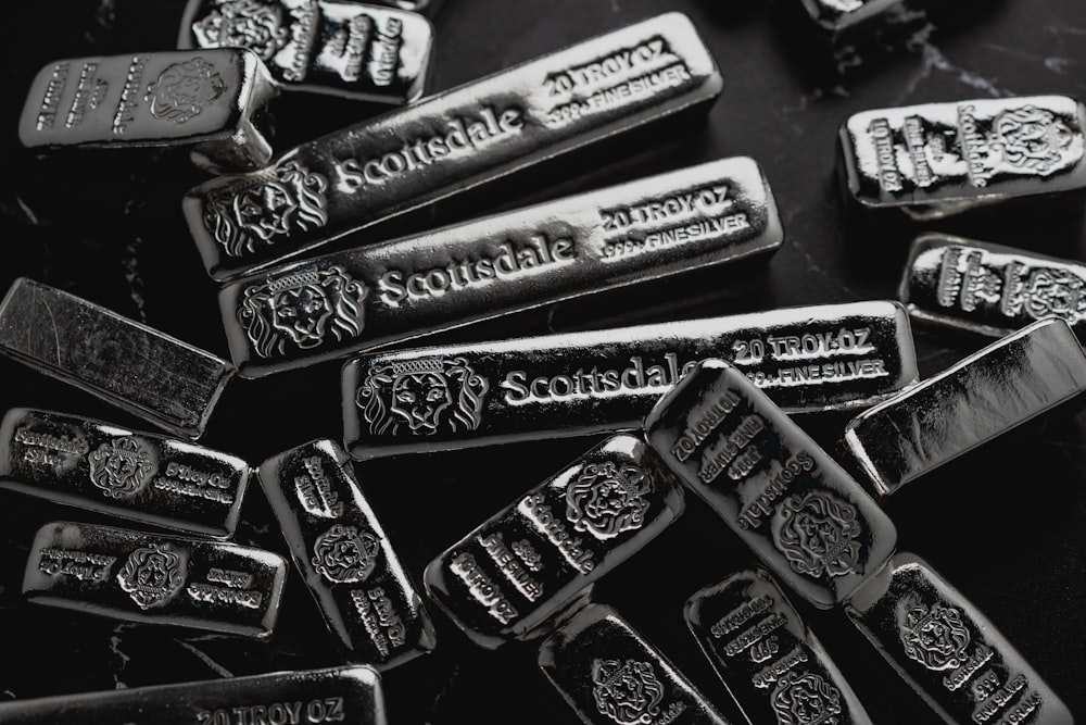 a pile of silver bars sitting on top of a table