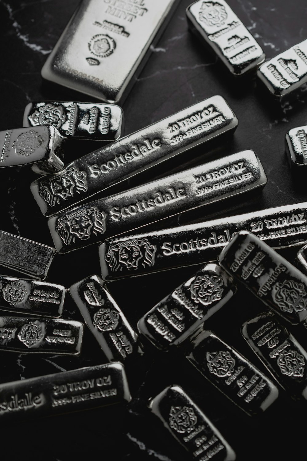 a pile of silver bars sitting on top of a table