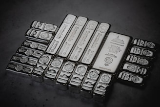 a pile of silver bars sitting on top of a table