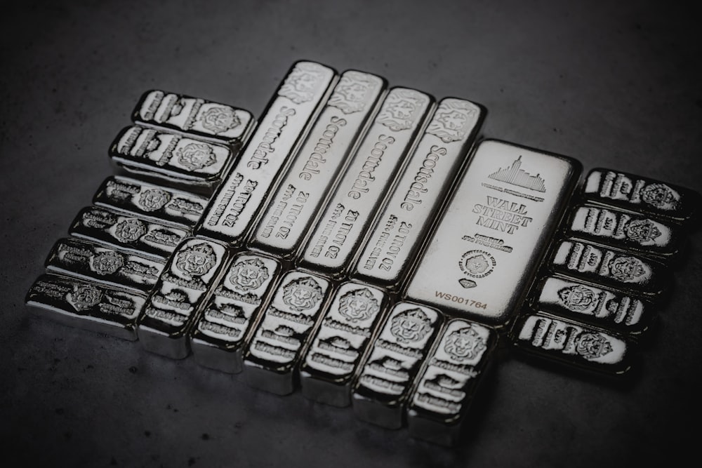 a pile of silver bars sitting on top of a table