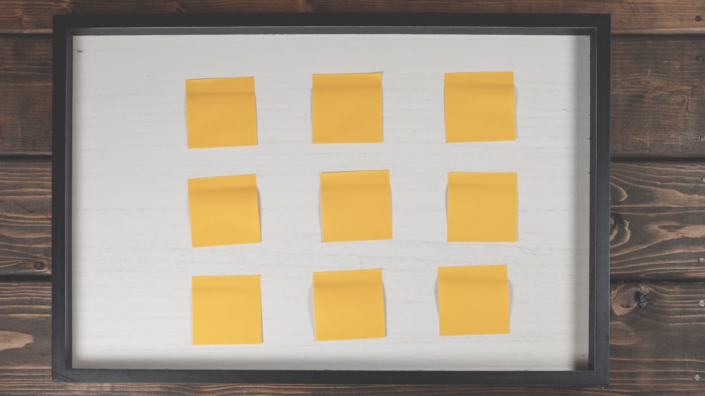 a picture of yellow sticky notes pinned to a white board