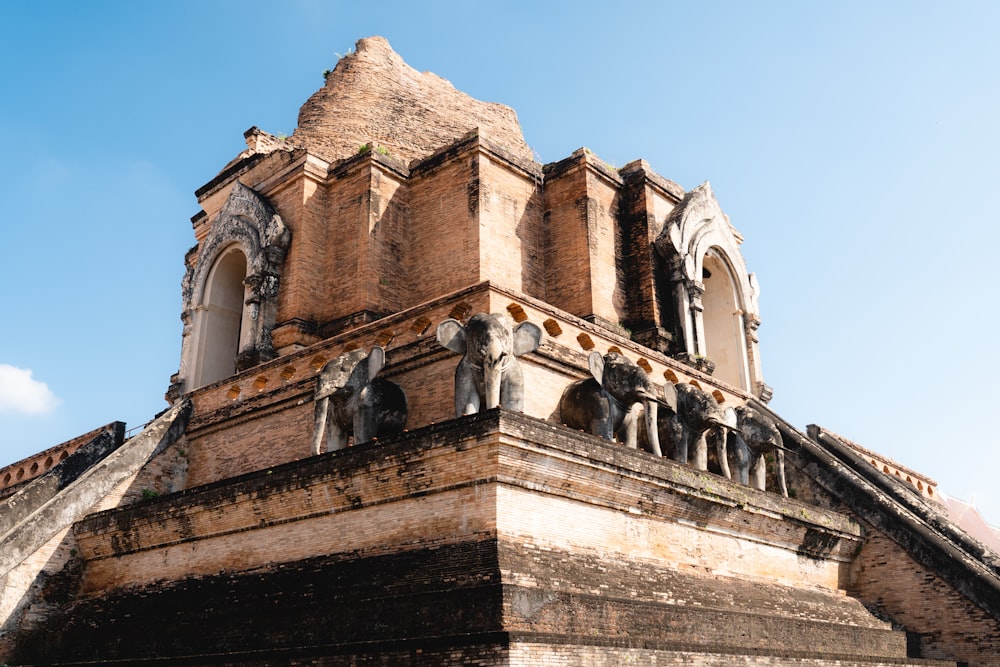 a tall tower with statues on top of it