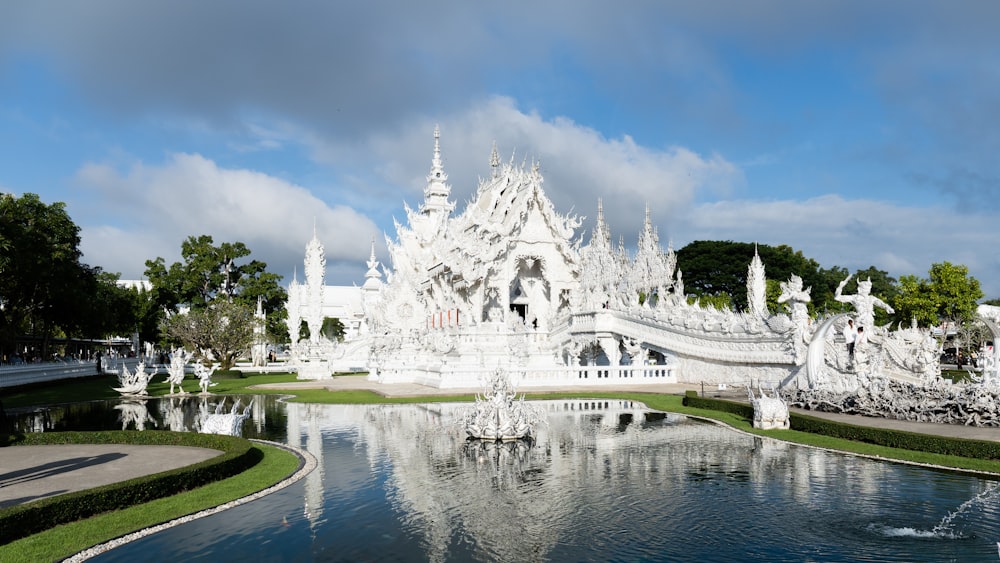 a large white building with a fountain in front of it