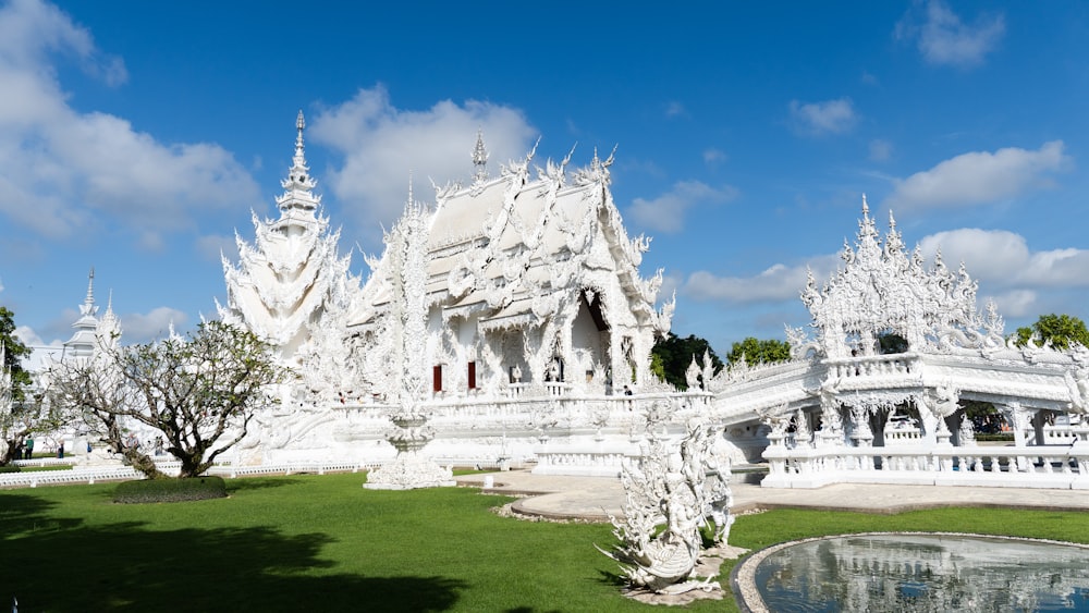 a large white building with a fountain in front of it