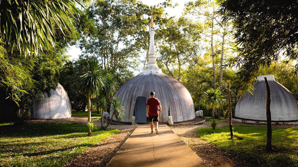 a man walking down a path in a park