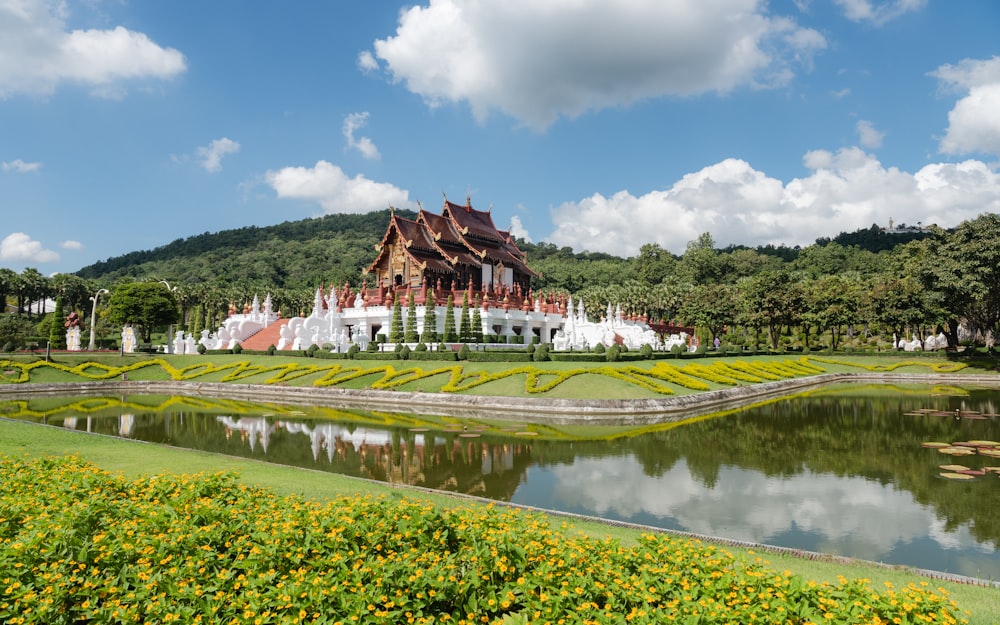 a large house sitting on top of a lush green field