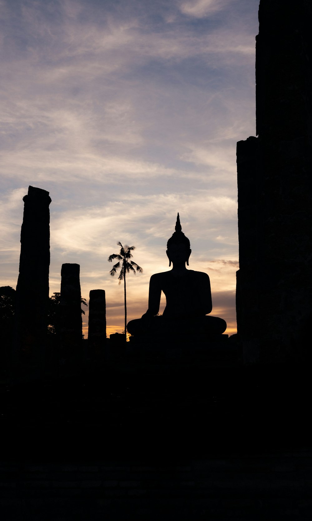 a buddha statue sitting in the middle of a city