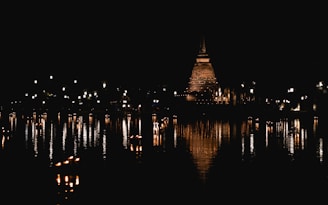 a large body of water with a clock tower in the background