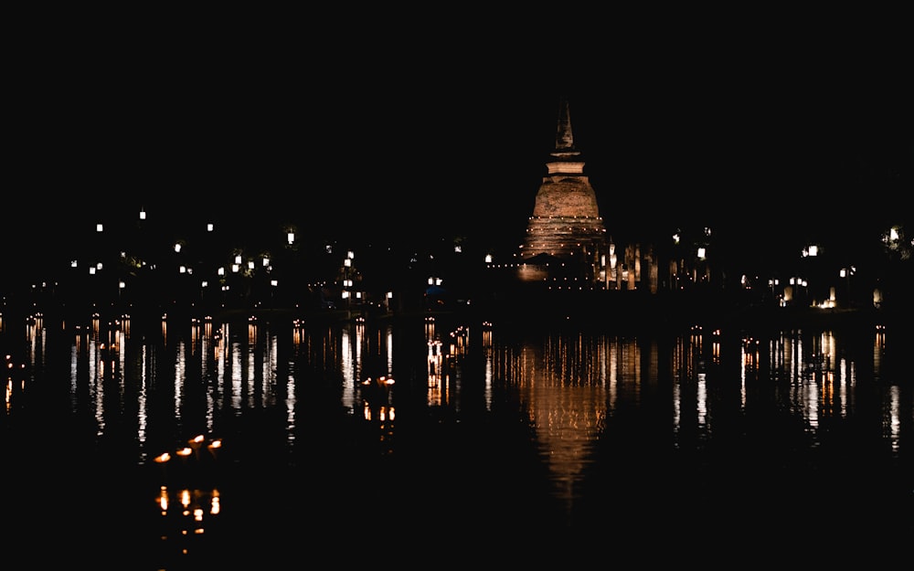 a large body of water with a clock tower in the background