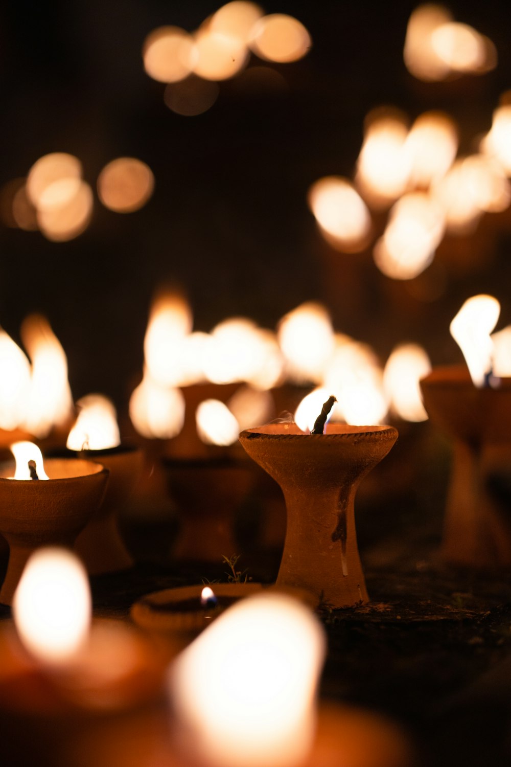 a group of lit candles sitting on top of a table