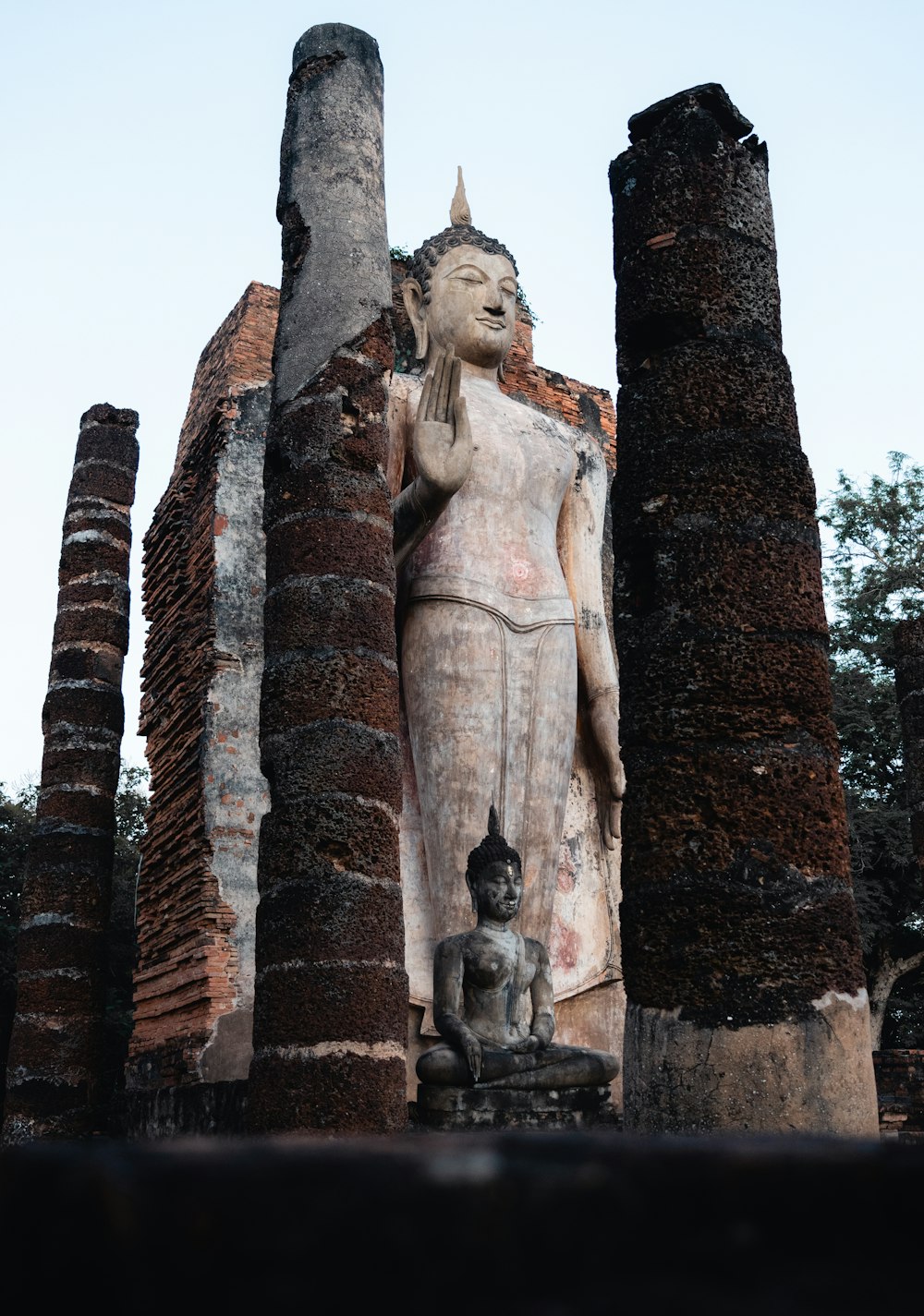 a statue of a person with a dog in front of it