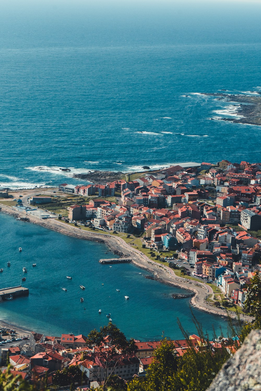 an aerial view of a small town by the ocean