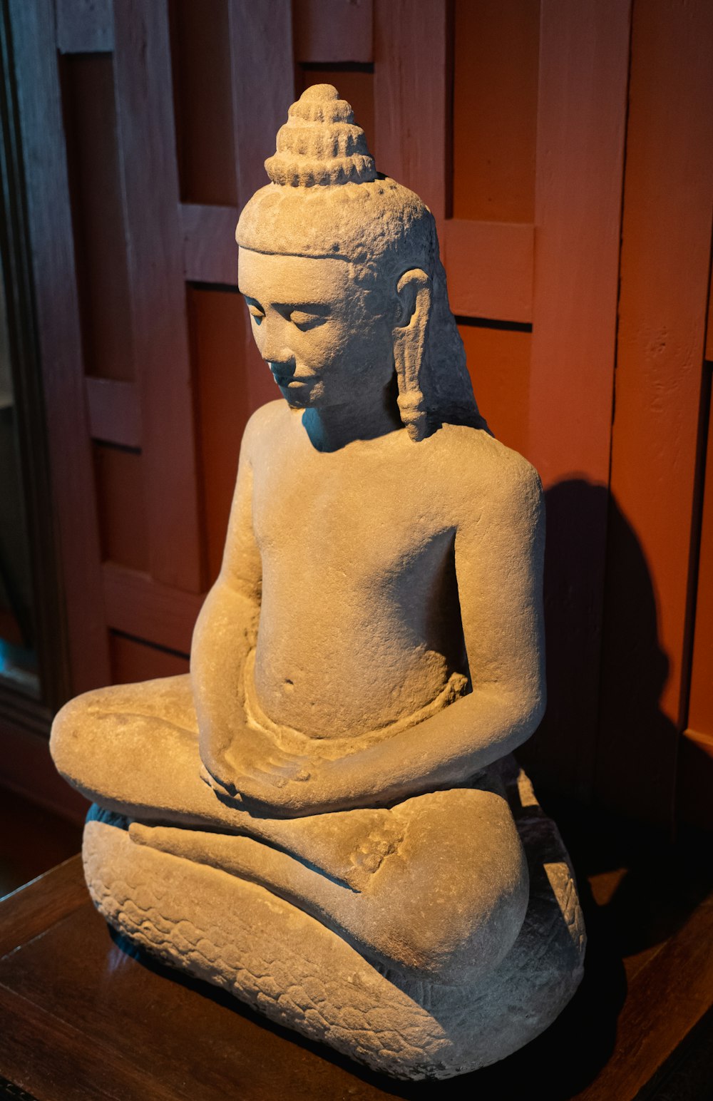 a statue of a buddha sitting on a table