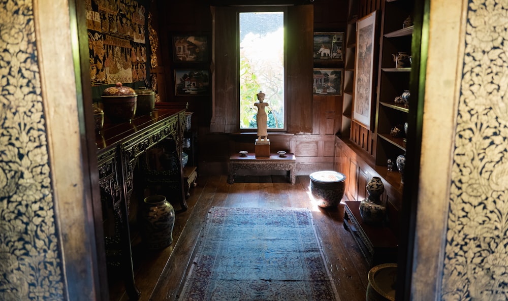 a room with a window and a rug on the floor