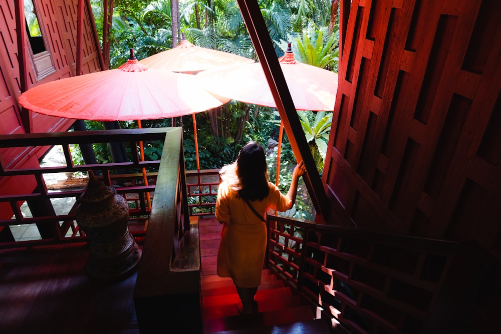 a woman in a yellow dress holding an umbrella