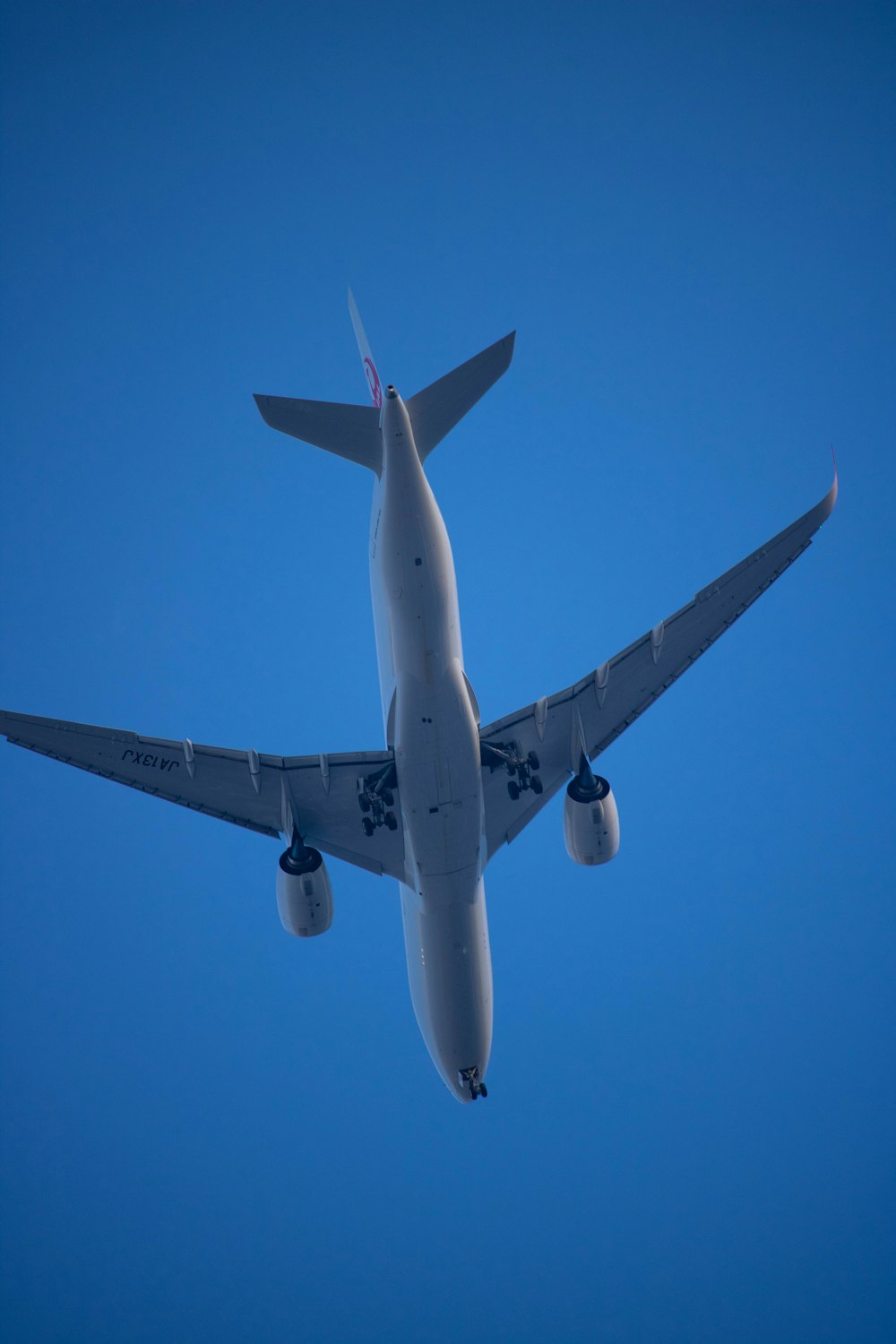 a large jetliner flying through a blue sky