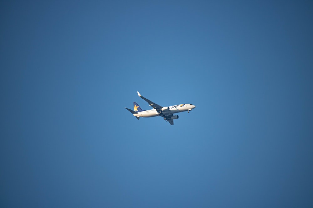 a large jetliner flying through a blue sky