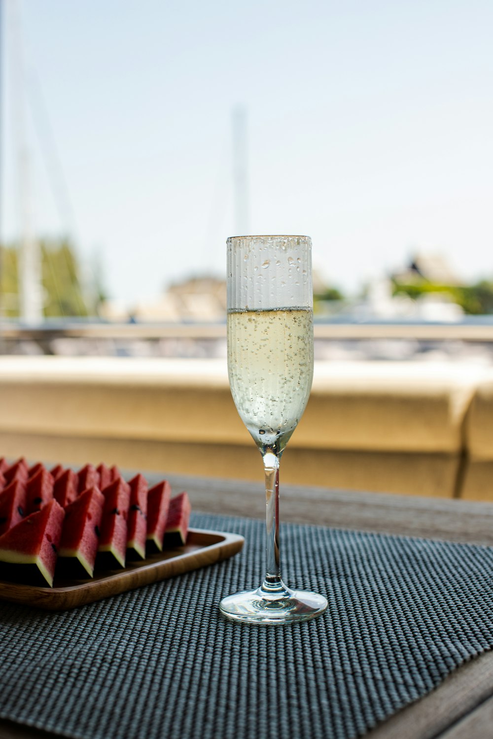 a glass of wine sitting on top of a wooden table