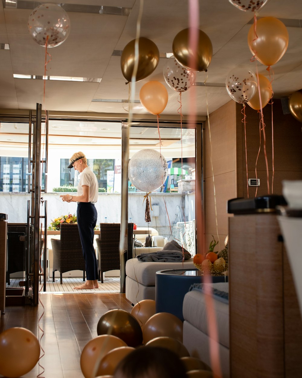 a woman standing in a room filled with balloons