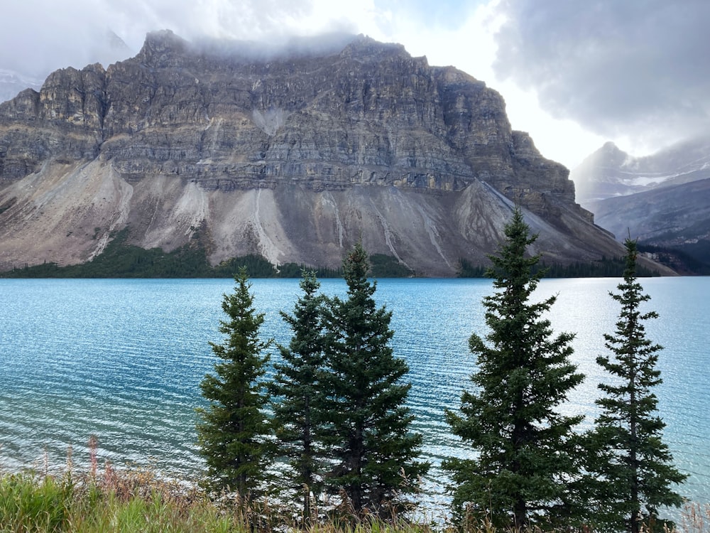 a mountain is in the background with a lake in the foreground