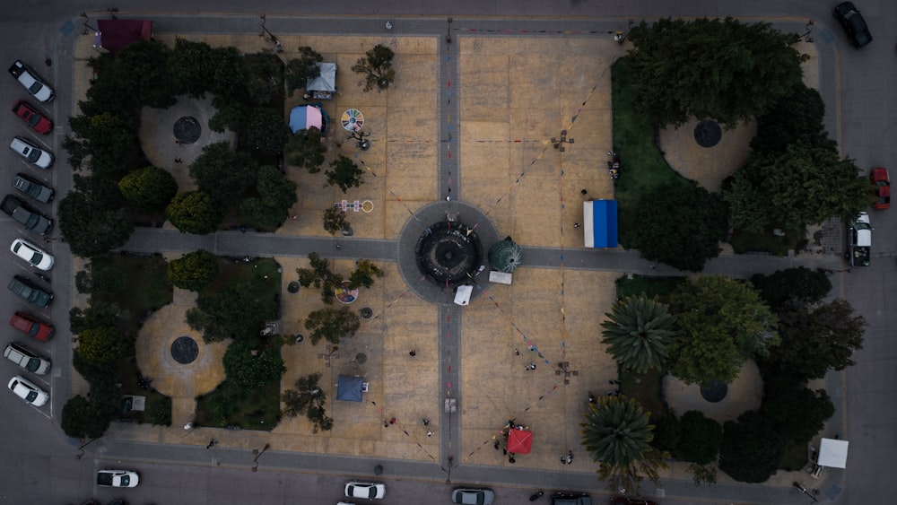 an aerial view of a parking lot with a fountain