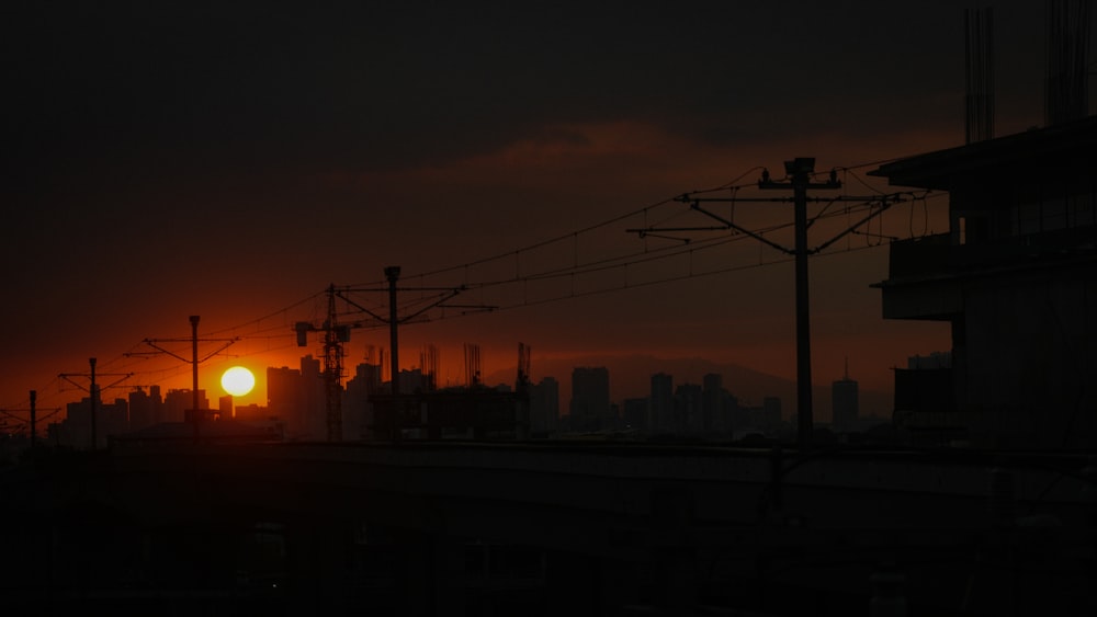 the sun is setting over a city skyline