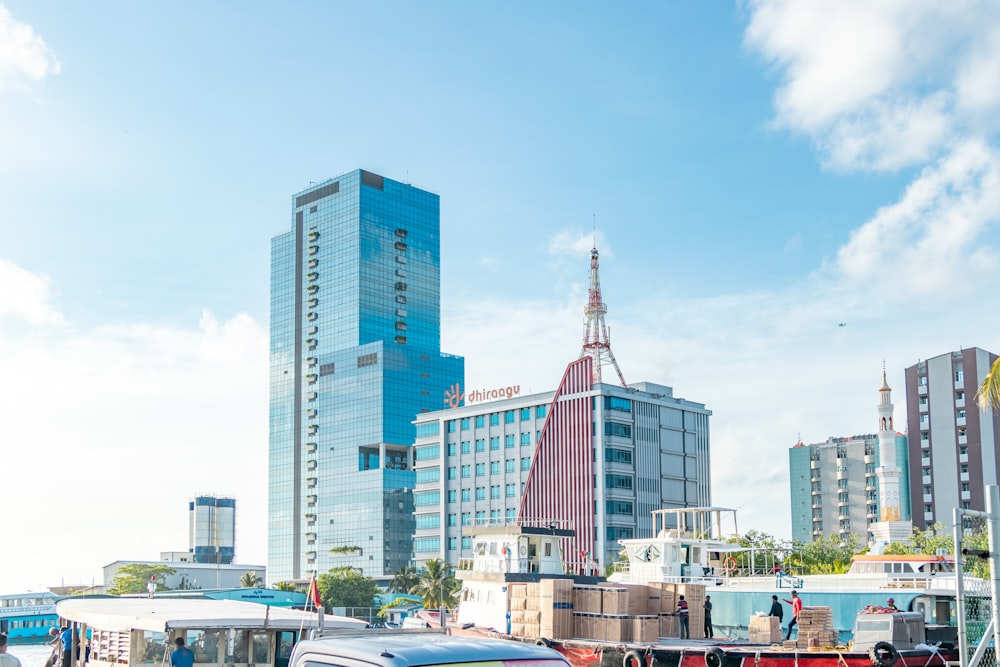 a group of vehicles parked next to each other in front of tall buildings