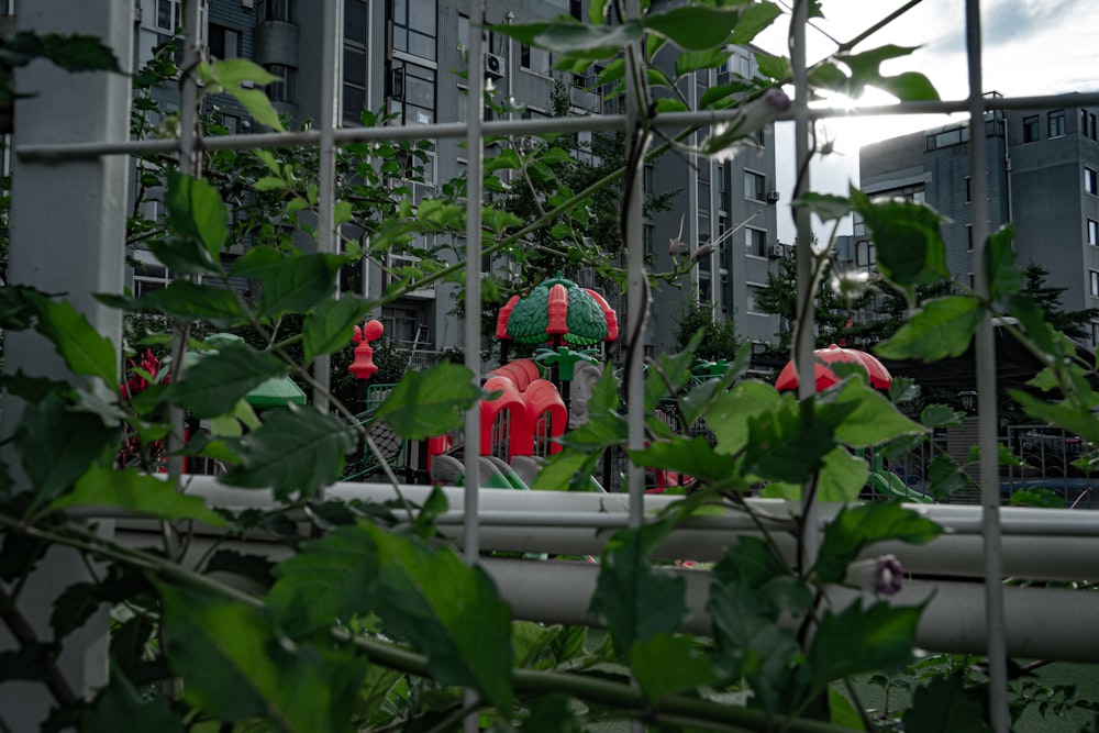 a group of red and green fire hydrants surrounded by greenery