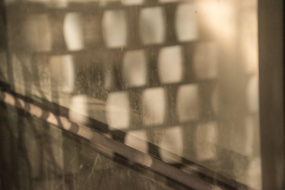 a close up of a window with a reflection of a building