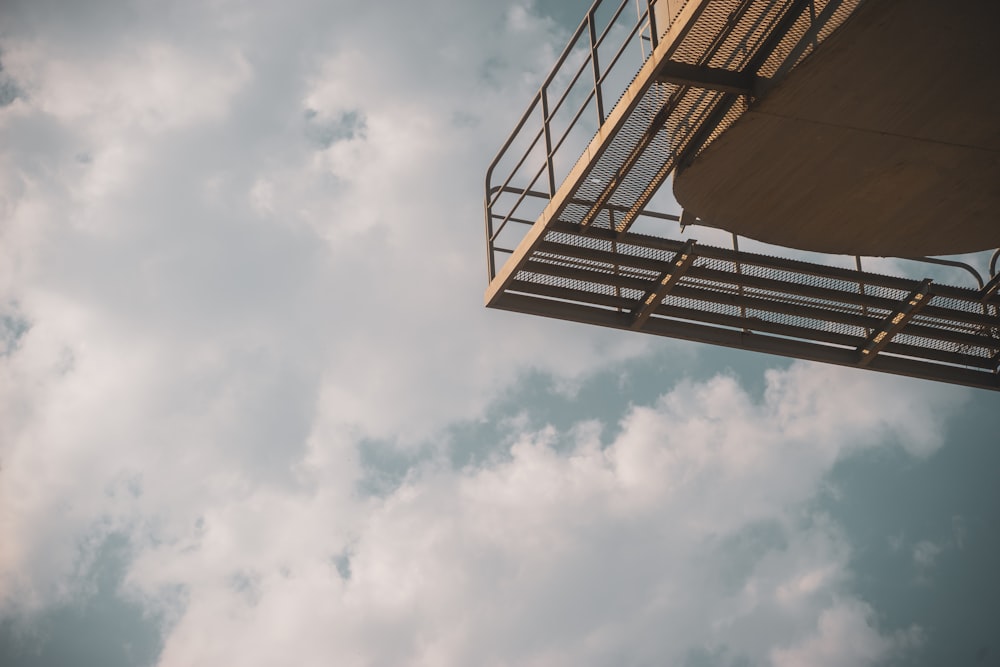 a tall building with a metal balcony on top of it