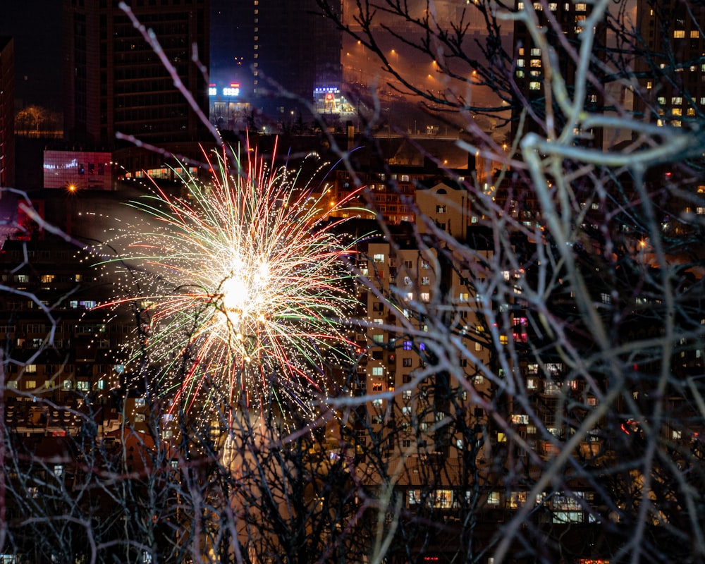 a fireworks display in a city at night