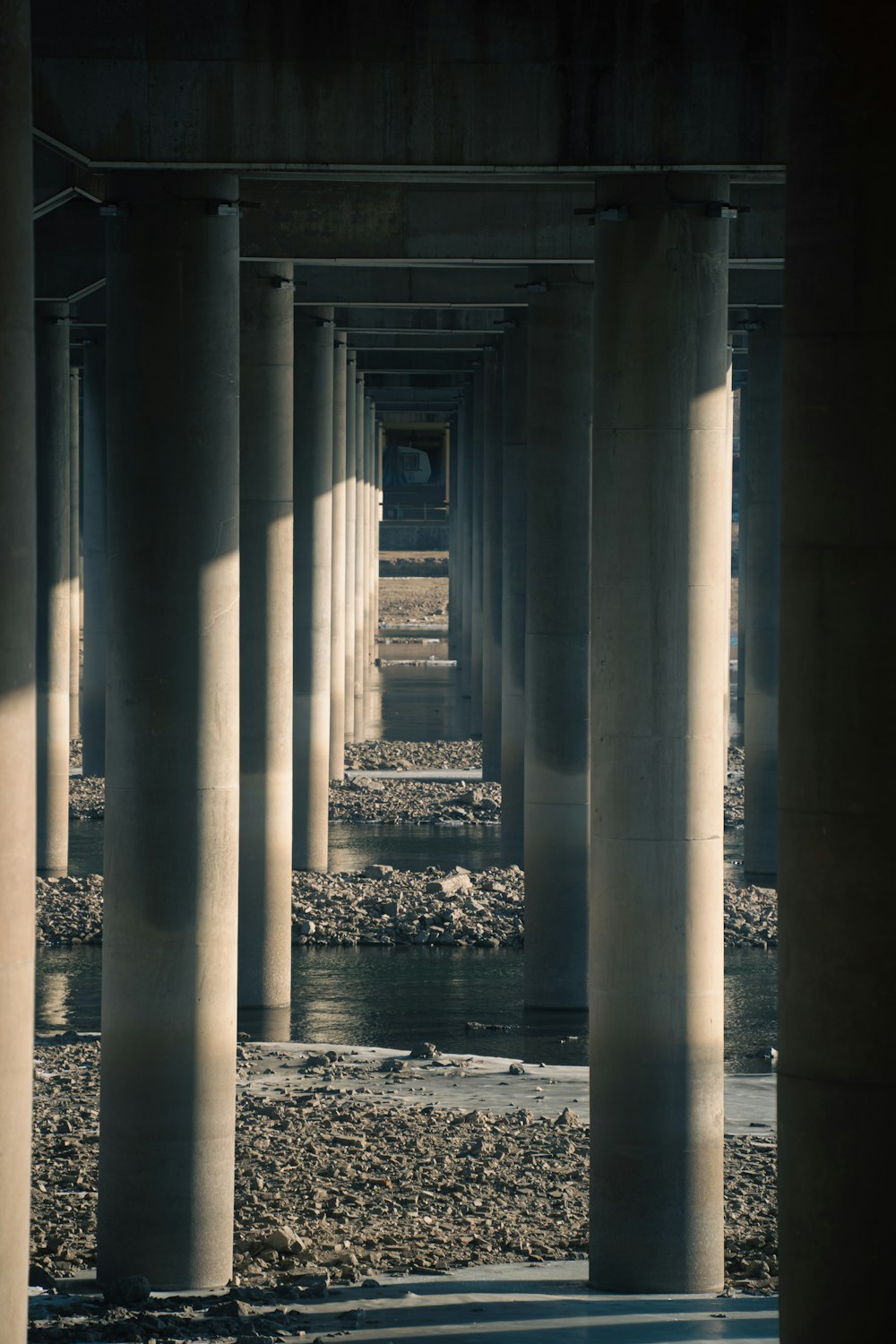 a black and white photo of a row of pillars