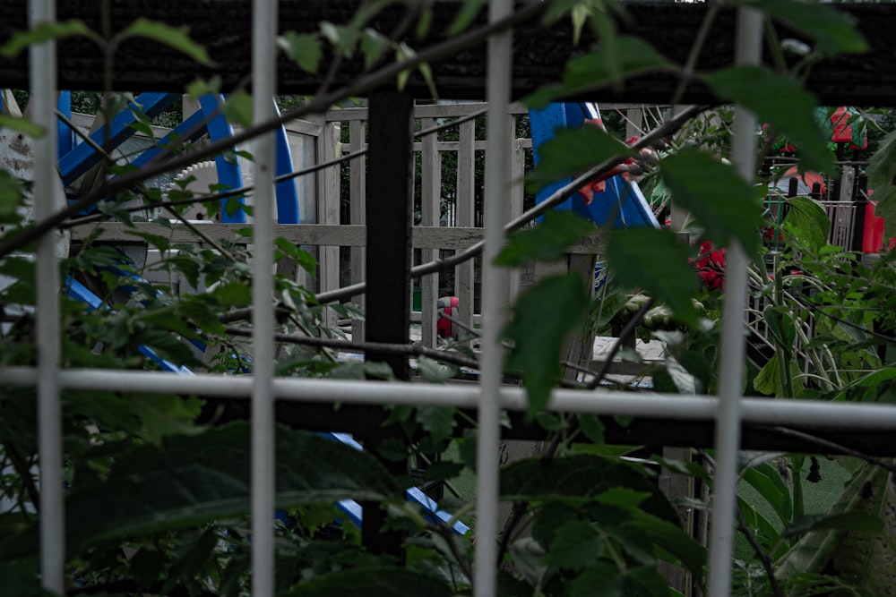 a view of a playground through a fence