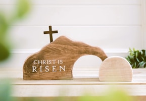 a small wooden church with a cross on top of it