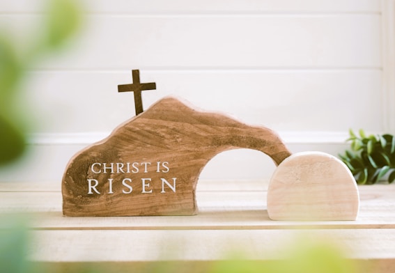 a small wooden church with a cross on top of it