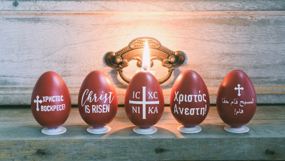 a group of red eggs sitting on top of a wooden table