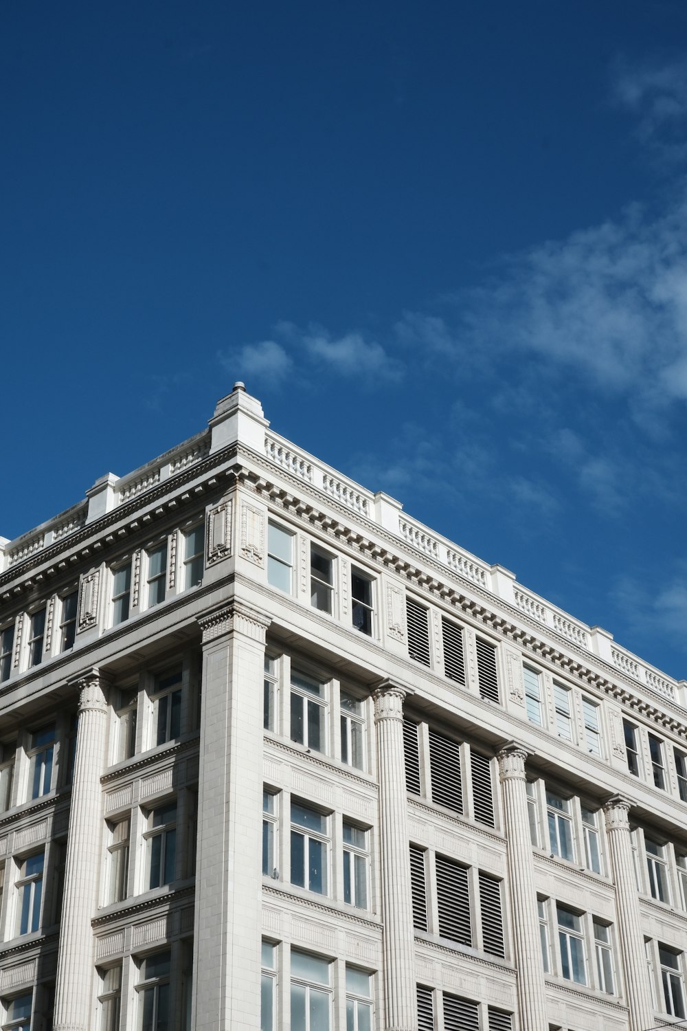 a large white building with a clock on the top of it